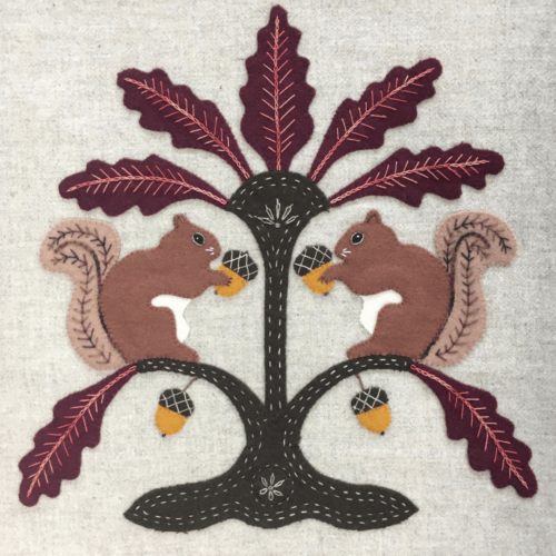 Wool Appliqué Block of wildlife quilt design by Carried Away Designs showing two brown squirrels with acorns on a branch