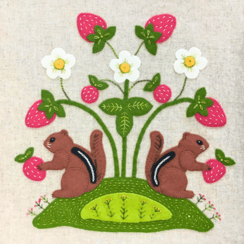 Wool Appliqué Block of wildlife quilt design by Carried Away Designs showing two brown chipmunks with strawberries on a branch