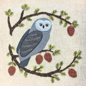 Wool Appliqué Block of wildlife quilt design by Carried Away Designs showing a gray owl on a branch with acorns