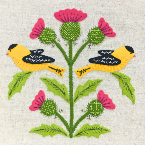 Wool Appliqué Block of wildlife quilt design by Carried Away Designs showing two goldfinches with red flowers