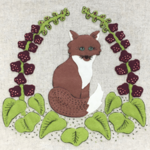 Wool Appliqué Block of wildlife quilt design by Carried Away Designs showing a brown fox sitting among plants