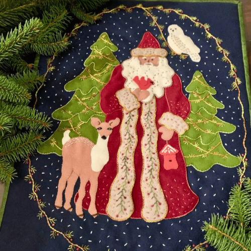 Carried Away Designs dark blue background with Saint Nicholas, reindeer, and evergreen trees wall quilt hanging