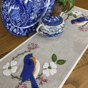 Carried Away Designs Wool linen color table mat with bluebirds and white flowers